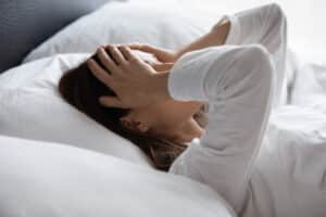 Woman in bed frustrated by Restless Leg Syndrome in Walnut Creek