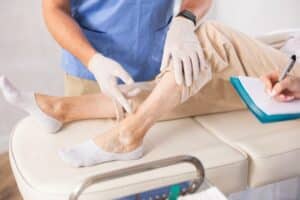 Doctor examining person's leg for foam sclerotherapy treatment in Walnut Creek, CA